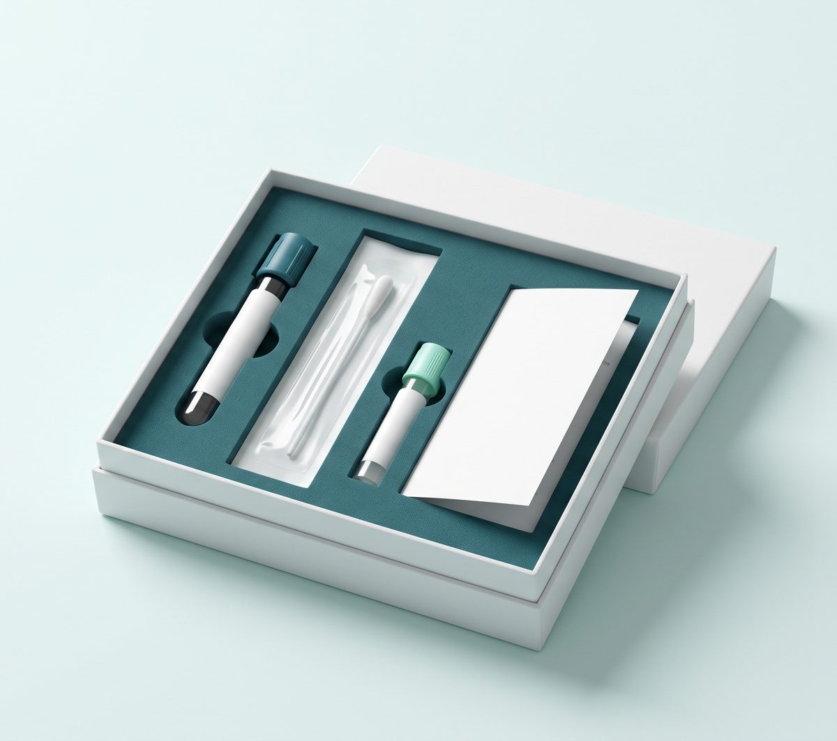 Open KITRIVO collection kit on a light background: white box with custom-cut teal foam holding a blood tube, sterile swab, saliva tube, and instruction card.